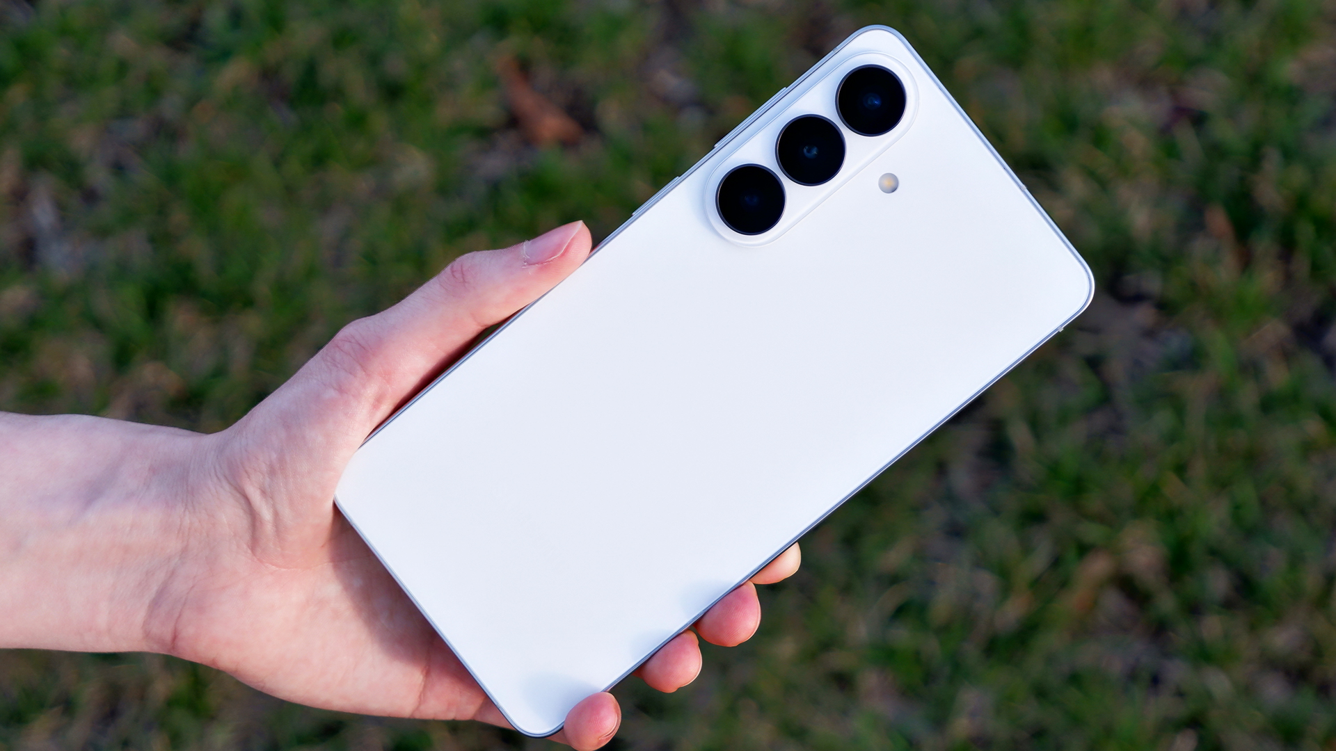 The back of the Samsung Galaxy S26 Plus against grass.