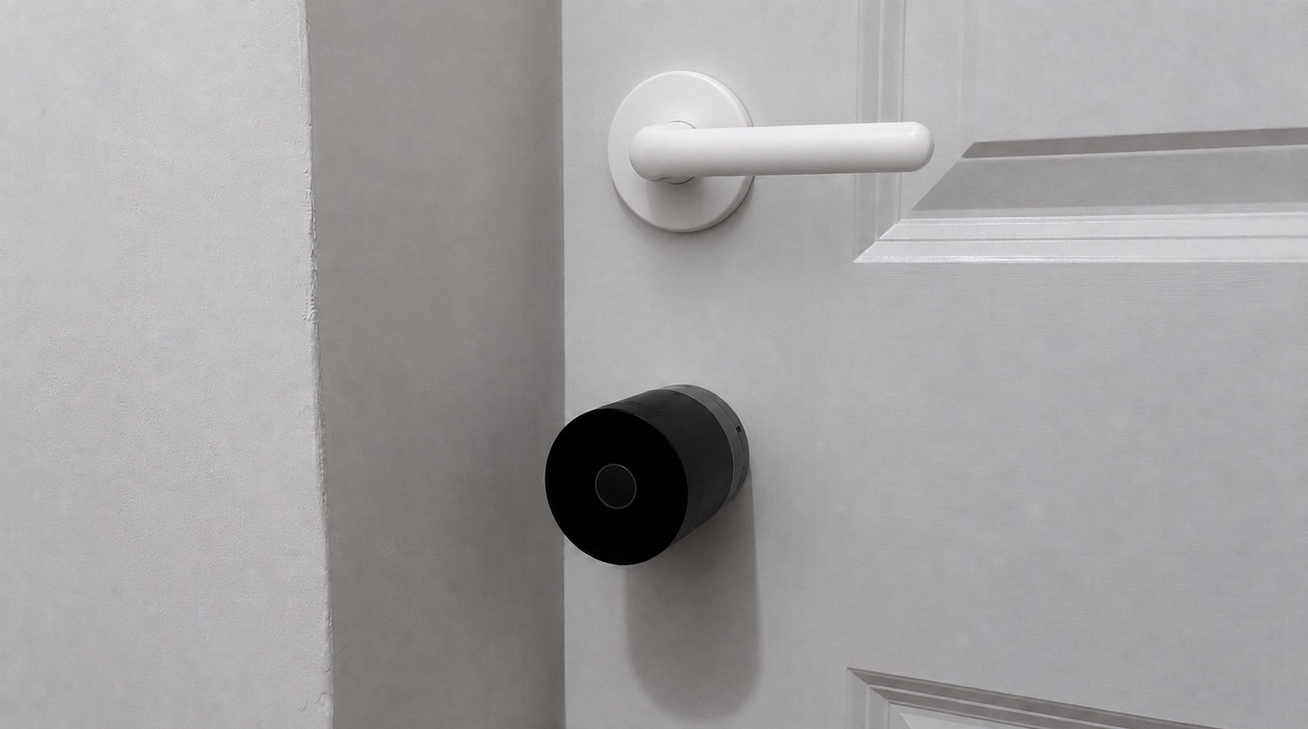 Yale Linus Smart Lock L2 Lite installed on door underneath door handle, with light off