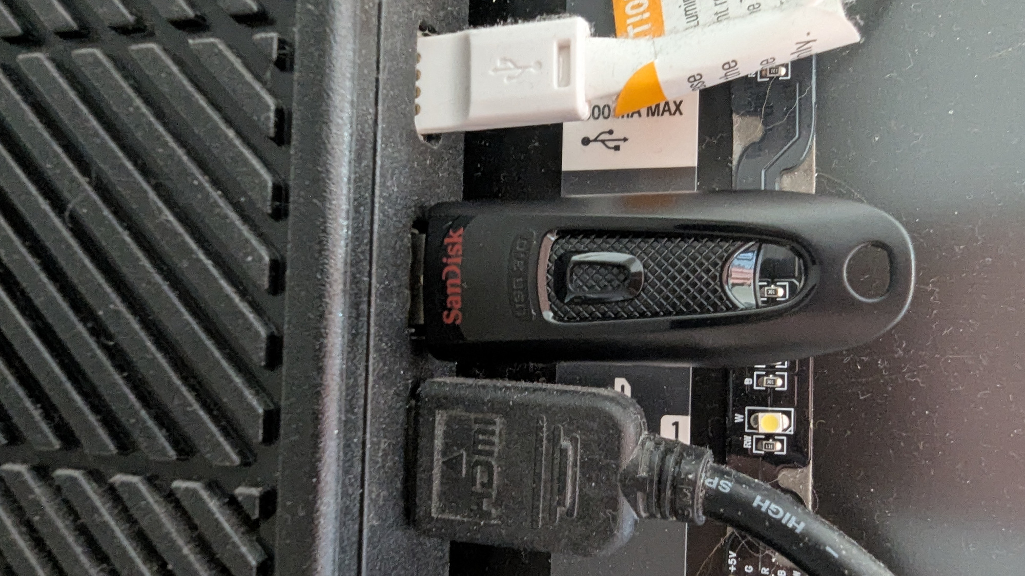 A USB stick plugged into the USB port around the back of a smart TV
