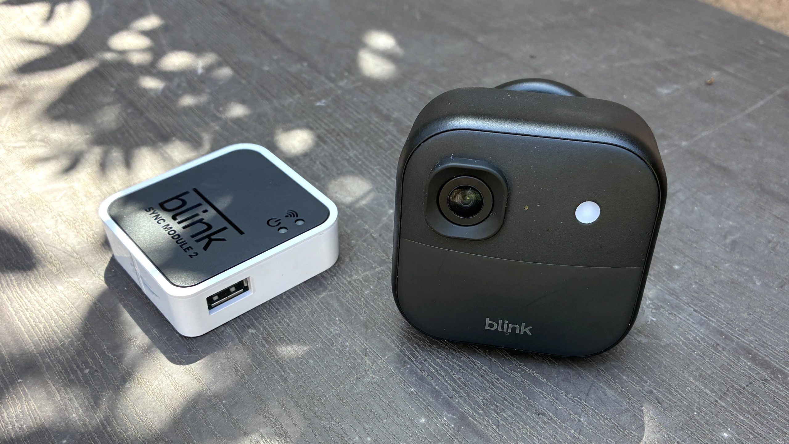 Blink Outdoor 2K+ security camera with hub on table