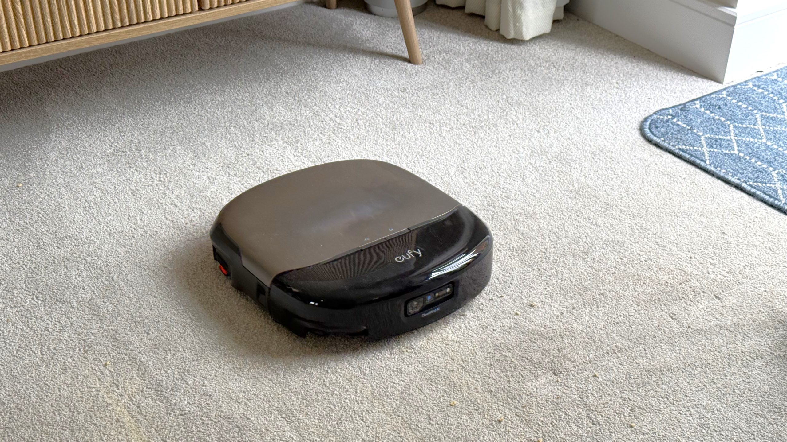 Eufy Omni S2 robot vacuum cleaning a carpeted floor