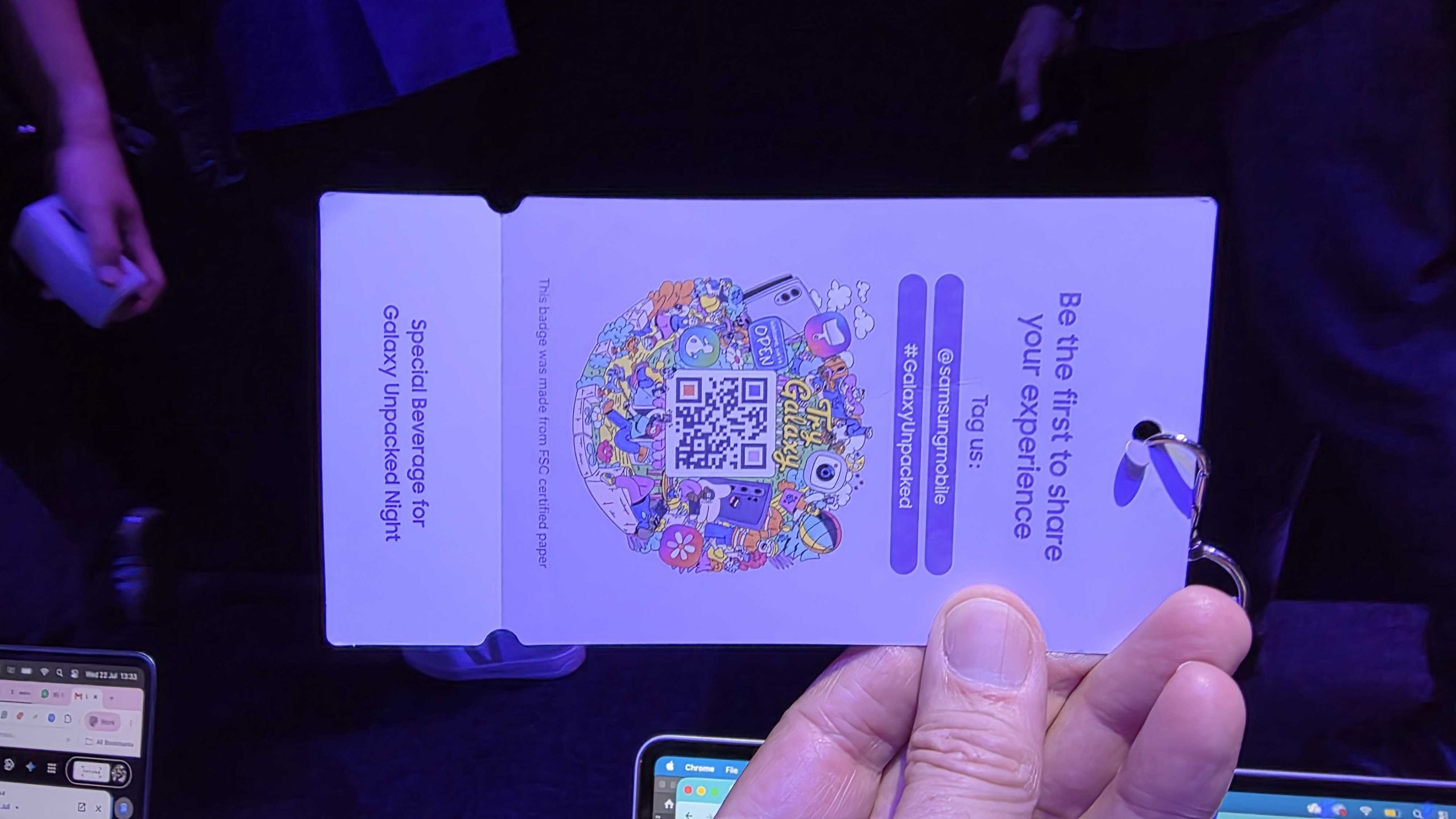 A hand holding the lanyard for the Samsung Galaxy Unpacked 2026 event