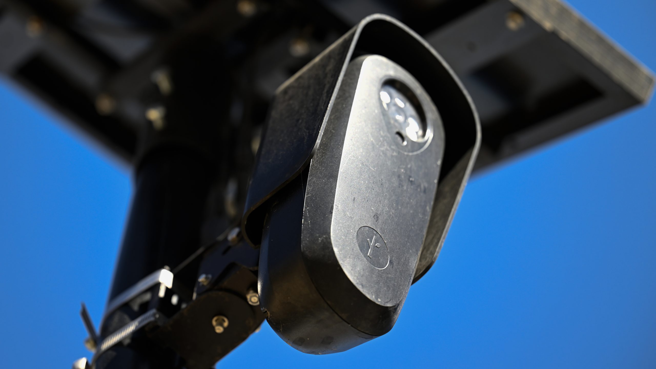 A flock camera in front of a blue sky