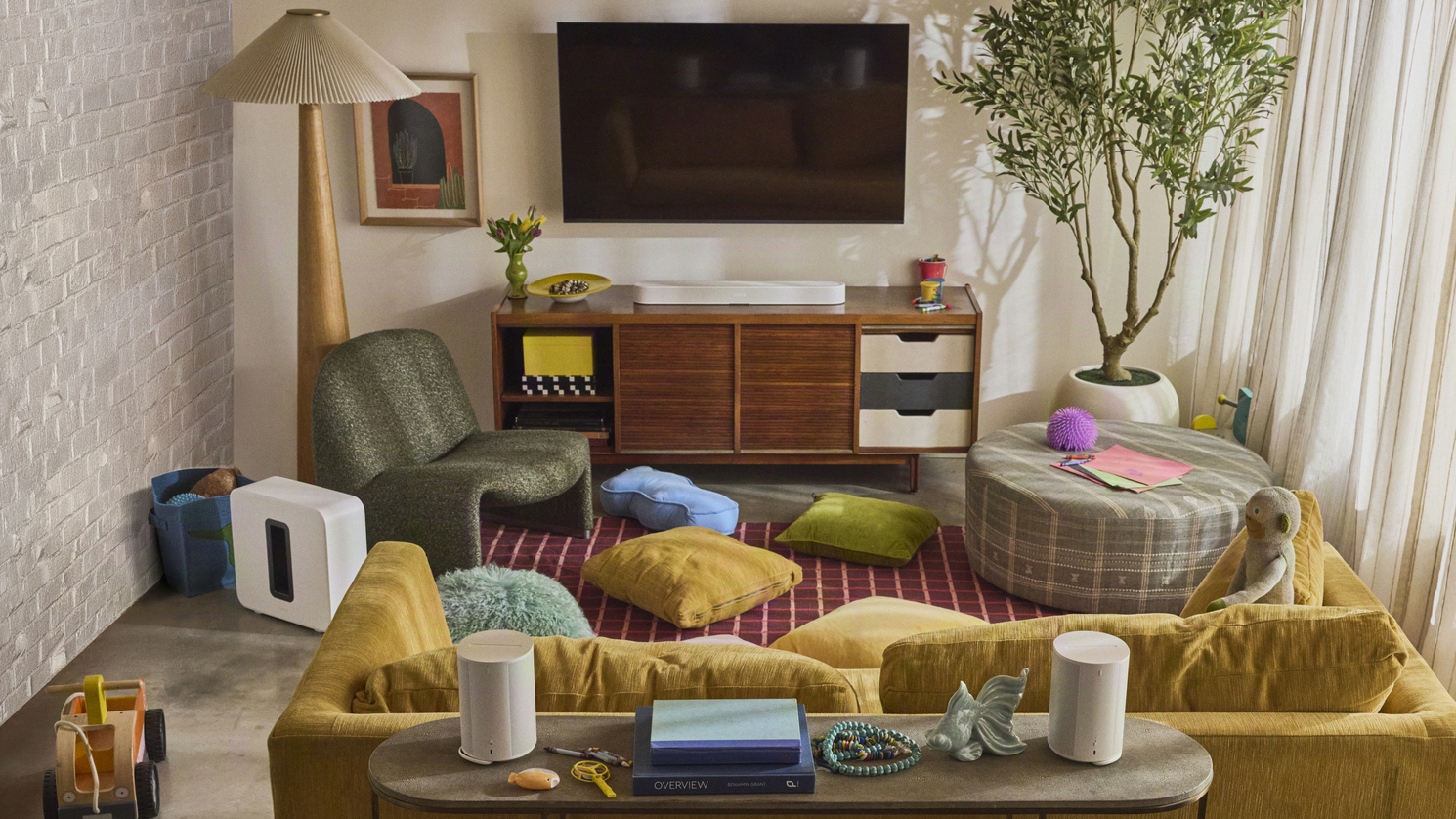 A living room containing various Sonos products, including the Sonos Beam Ultra below a TV